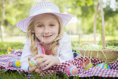 Cute Young Girl Wearing Hat Enjoys Her Easter Eggs