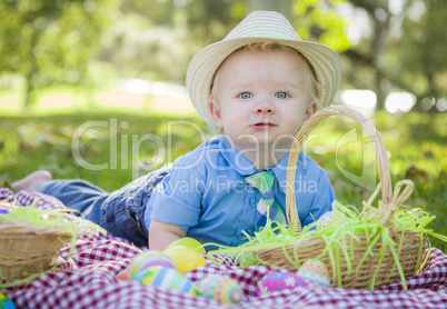 Cute Little Boy Smiles With Easter Eggs Around Him