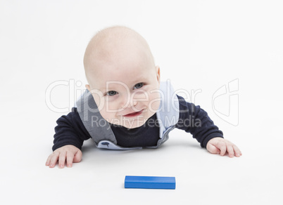 interested baby with toy block