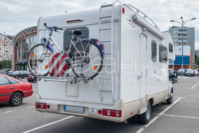 camper with bicycle in city