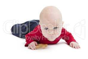 toddler with toy and red shirt crawling