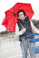 woman with shopping cart and umbrella