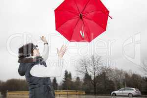 woman is running her umbrella flying away