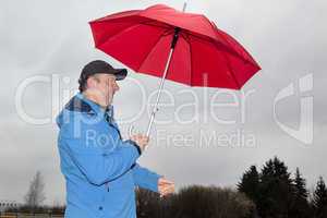 man running with umbrella in rainy stormy weather