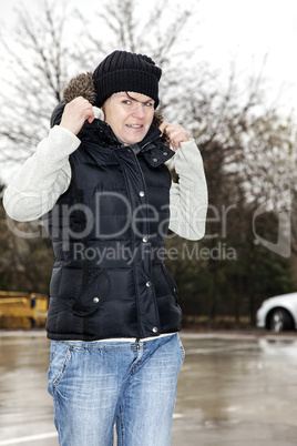 woman with wool hat walks across the parking