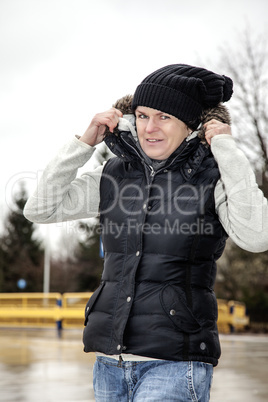 woman with wool hat walks across the parking