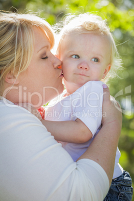 Young Mother Kissing and Holding Her Adorable Baby Boy