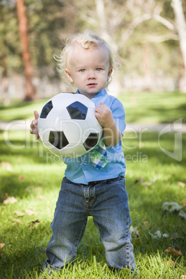 Young Cute Boy Playing with Soccer Ball in Park