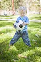 Young Cute Boy Playing with Soccer Ball in Park