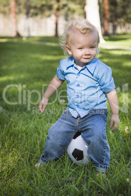 Young Cute Boy Playing with Soccer Ball in Park