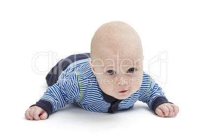 attentive baby laying on ground