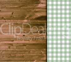 Holz-Hintergund mit Tischdecke mit Karos in grün und weiß