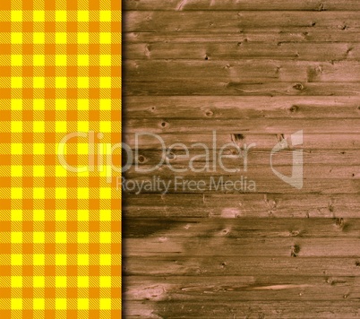 Holz-Hintergrund und Tischdecke in orange und gelb