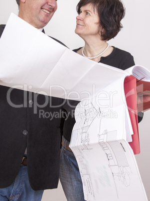 man and woman with blueprint