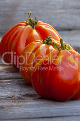 three large beefsteak tomatoes in a row