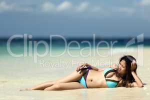 filipina woman lying on sand