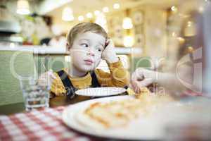 bored little boy in a restaurant
