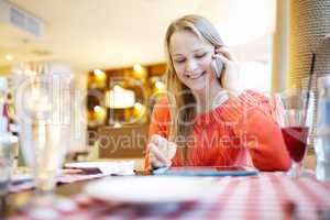 woman in cafe with touchpad and phone