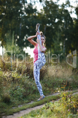 athletic young woman working out in the country