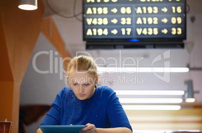 woman with touchpad in the waiting room