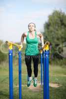 woman gymnast exercising on parallel bars