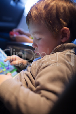 little boy playing on a tablet computer
