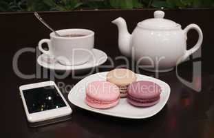 tea and macaroons with a tablet computer