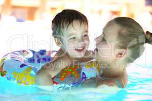 mother and her son in the outdoor swimming pool