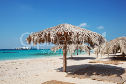 straw beach umbrellas at a tropical resort