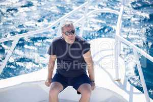 man sitting on the prow of a boat