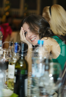 happy smiling woman sitting at a bar counter