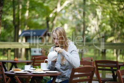 young woman enjoying a pot of tea