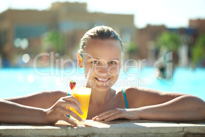 beautiful young woman drinking a cocktail