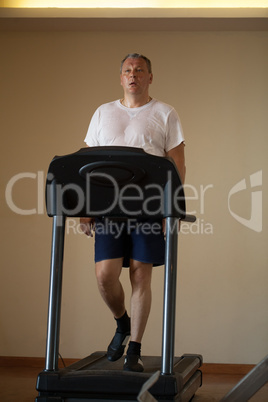 middle-aged man working out on a treadmill