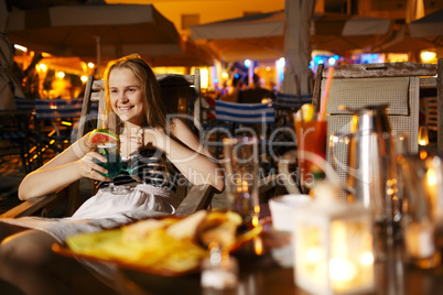 smiling woman drinking in a cafeteria