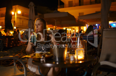 woman enjoying a drink in a pub or restaurant