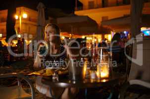 woman enjoying a drink in a pub or restaurant