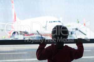 little boy watching planes at the airport