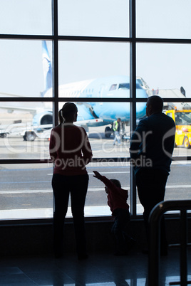 young family watching planes at an airport