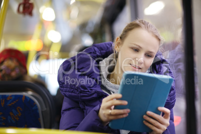 woman with touchpad in the bus