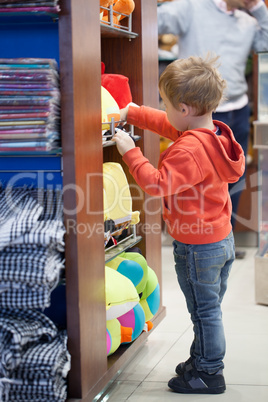 cute little boy shopping for a beach accessories