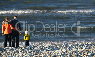 family of three on pebble beach