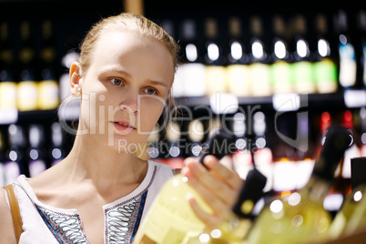 woman shopping for alcohol in a bottle store
