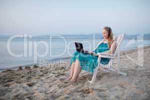 woman talking skype at the beach