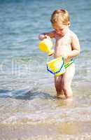 adorable little boy playing in the sea