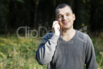 man laughing as he chats on his mobile