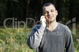 man laughing as he chats on his mobile