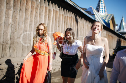 bride and her bridesmaid walking with friends
