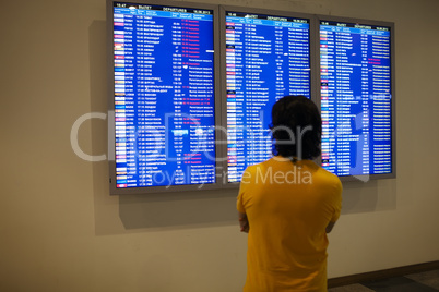 passenger studying an information board