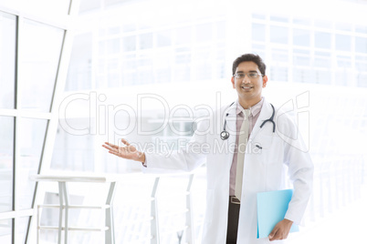 asian indian male medical doctor showing welcome hand sign